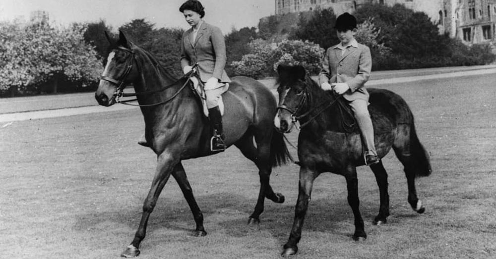 Queen Elizabeth riding with her son Prince Charles